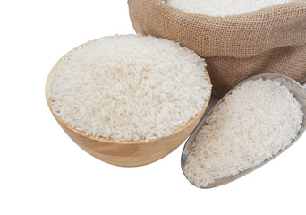 Rice in wooden bowl and in burlap sack with metallic scoop isolated on white background