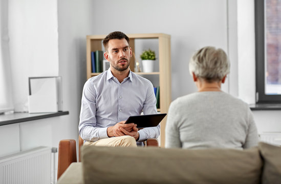 Geriatric Psychology, Mental Therapy And Old Age Concept - Psychologist With Tablet Computer Listening To Senior Woman Patient At Psychotherapy Session