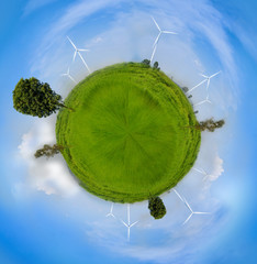 Globe sphre effect Electrical Eco power maker wind turbine in fresh green field against blue sky