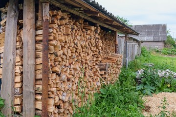 stack of cut firewood for a log burning stove in countryside