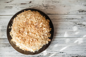 Slice Confectionery Napoleon Cake. Portion of Custard Cream Dessert copy space. Crumbs Around Plate. Bakery Tasty Sweet Dish Closeup