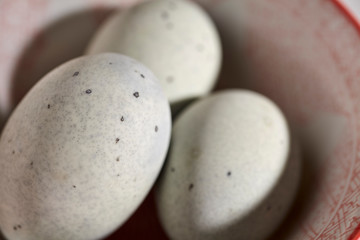 Two unpeeled preserved duck eggs, sometimes called century eggs, thousand year old eggs, or...