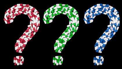 question mark written in blue green red and white medical capsules, isolated on a black background