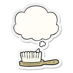 cartoon hairbrush and thought bubble as a printed sticker