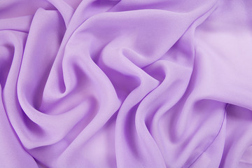 Obraz premium The texture of the satin fabric of lilac color for the background