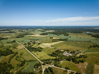 countryside roads and fields with small village. aerial view