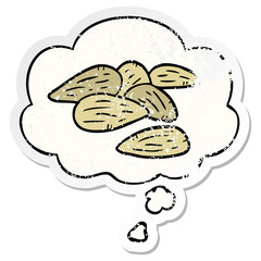cartoon almonds and thought bubble as a distressed worn sticker