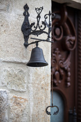 Obraz premium Vintage classic door bell of an old stone house with a vintage brown door