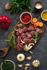 Cuts beef with vegetable. kitchen table with ingredients cooking meat and veggies
