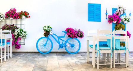Fototapeta na wymiar Charming street (outdoor) decoration with old bicycle and flowers. Bodrum, Turkey