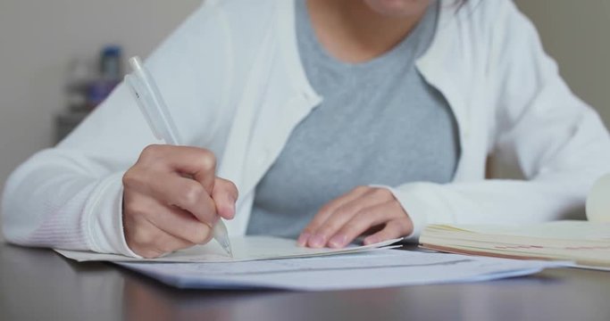Woman study at home, write her essay
