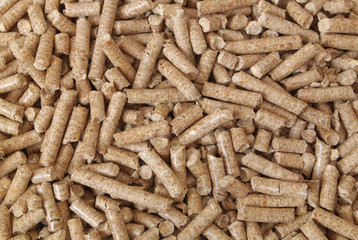 Natural wooden pellets background or pattern. Cheap energy and cats litter.