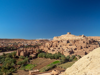Fototapeta na wymiar Ait Ben Haddou Kasbah, old medieval town in Morocco desert, castle fort gate, clay mud houses ruins, river in the mountiains
