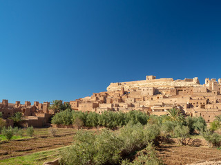 Fototapeta na wymiar Ait Ben Haddou Kasbah, old medieval town in Morocco desert, castle fort gate, clay mud houses ruins, river in the mountiains