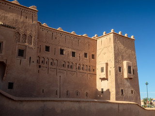 Fototapeta premium Taourirt Kasbah, Ouarzazate, Morocco, North Africa [Moroccan mountain landscape, old ancient Taourirt Kasbah castle fortress, street and buildings with kids and market]