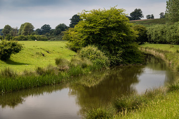 English country landscape with river and reflections