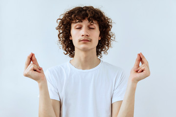 Keep balance. Calm and rest Curly guy portrait against white background