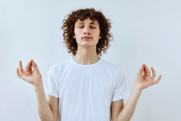 Keep balance. Calm and rest Curly guy portrait against white background