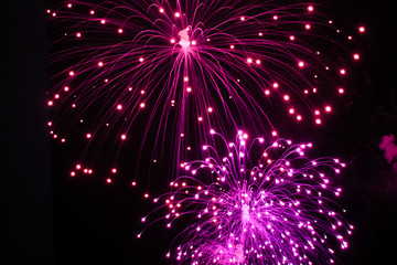 Fototapeta premium Beautiful sparks from fireworks in sky at night