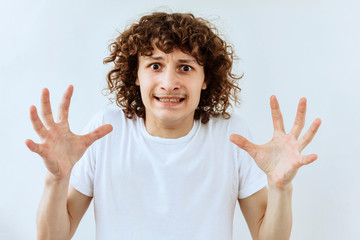 Furious, Frustrated and stress emotion. Portrait of Curly teen guy against white background