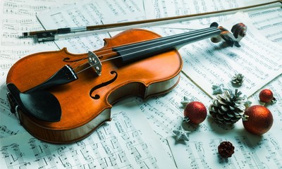 Fototapeta premium Close-up Photo Of Violin, Musical Notes and Christmas decoration