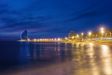 Fototapeta na wymiar Barcelona Beach in summer night along seaside in Barcelona, Spain. Mediterranean Sea in Spain.