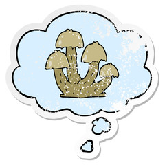 cartoon mushrooms and thought bubble as a distressed worn sticker