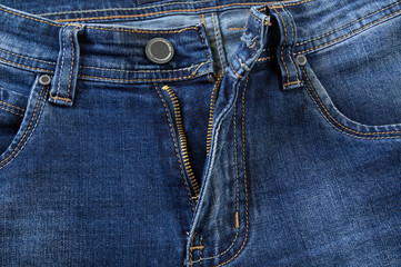 Blue jeans pocket, button and open zipper