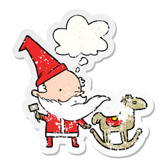 cartoon santa making toy and thought bubble as a distressed worn sticker