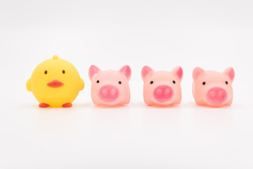 Yellow chick and 2 pink pig cartoon animal toys neatly arranged on a white background