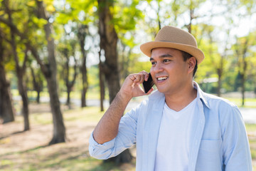 Asian man using smartphone in park