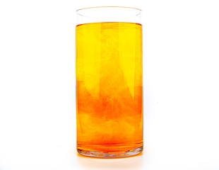 Orange food coloring diffuse in water inside tall glass with empty copyspace area for slogan or advertising text message, over isolated white background.