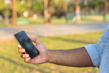 Asian man using smartphone in park