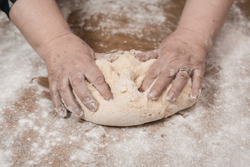 Obraz premium Hands kneading dough for gnocchi.