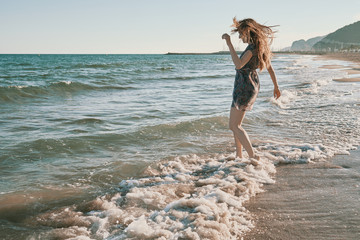a happy young woman at the beach