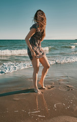 a happy young woman at the beach