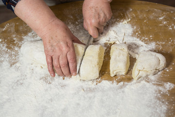 Hands kneading dough for gnocchi.