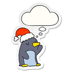 cute cartoon christmas penguin and thought bubble as a printed sticker