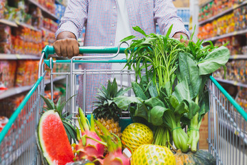Young man shopping at supermarket.