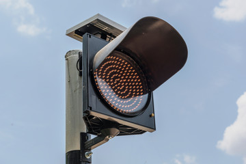 City stop lights with clouds and blue sky.
