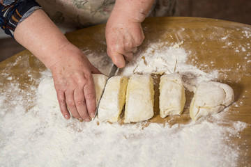 Hands kneading dough for gnocchi.