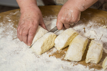 Hands kneading dough for gnocchi.