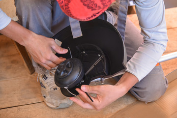 Trimmer close up mow the grass with a lawnmower. Gardening with a brush cutter Close-up. Lawn care with brush cutters. Male worker cleans the trimmer. mowing the lawn.