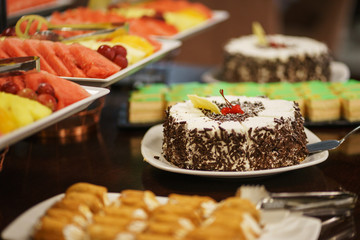 Sweet desserts, pastries on the table during the event. Catering servicing of guests and participants during mass events.