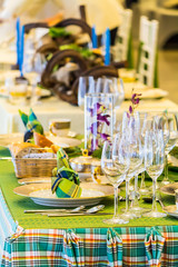 Luxury party dinner table setting with tableware and silverware and glasses set and Candlestick and flower in restaurant.