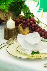 Luxury party dinner table setting with tableware and silverware and glasses set and Candlestick and flower in restaurant.
