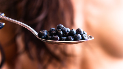 blueberries on the spoon close-up. use blueberries to improve human vision