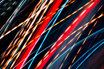 Colorful pattern of red, blue and orange dynamic lines of light. Modern blurred background. Art concept of lighting effects.