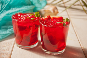 Glasses with fresh homemade strawberry sweet iced tea or cocktail, lemonade with mint. Refreshing cold drink. Summer pool party. Marine theme.