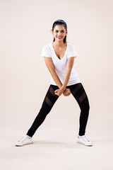 The young woman doing Zumba dance workout,corssing her arms and point down,show basic pattern,for exercise,